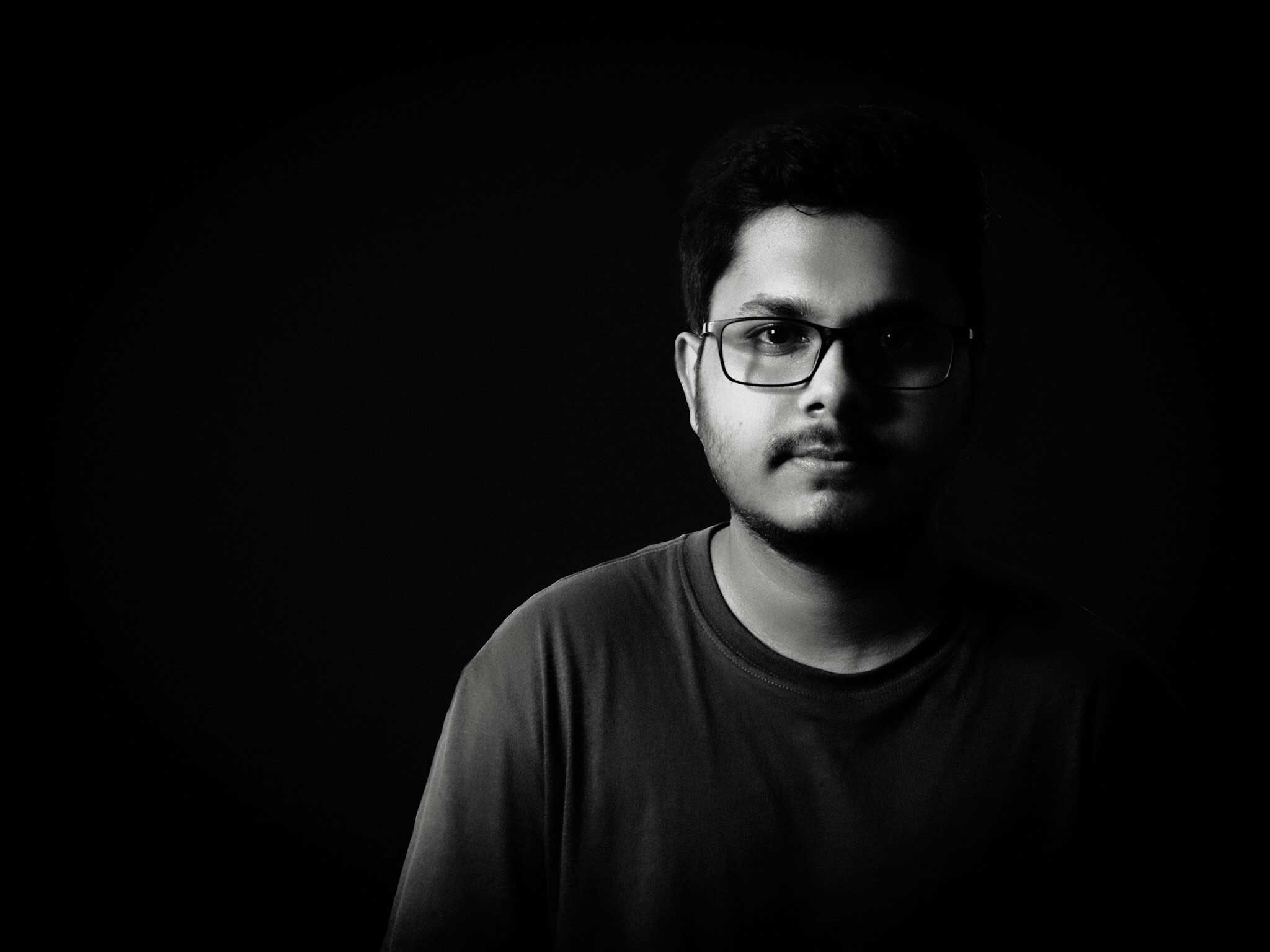 Portrait of Amitesh in low-key black and white lighting